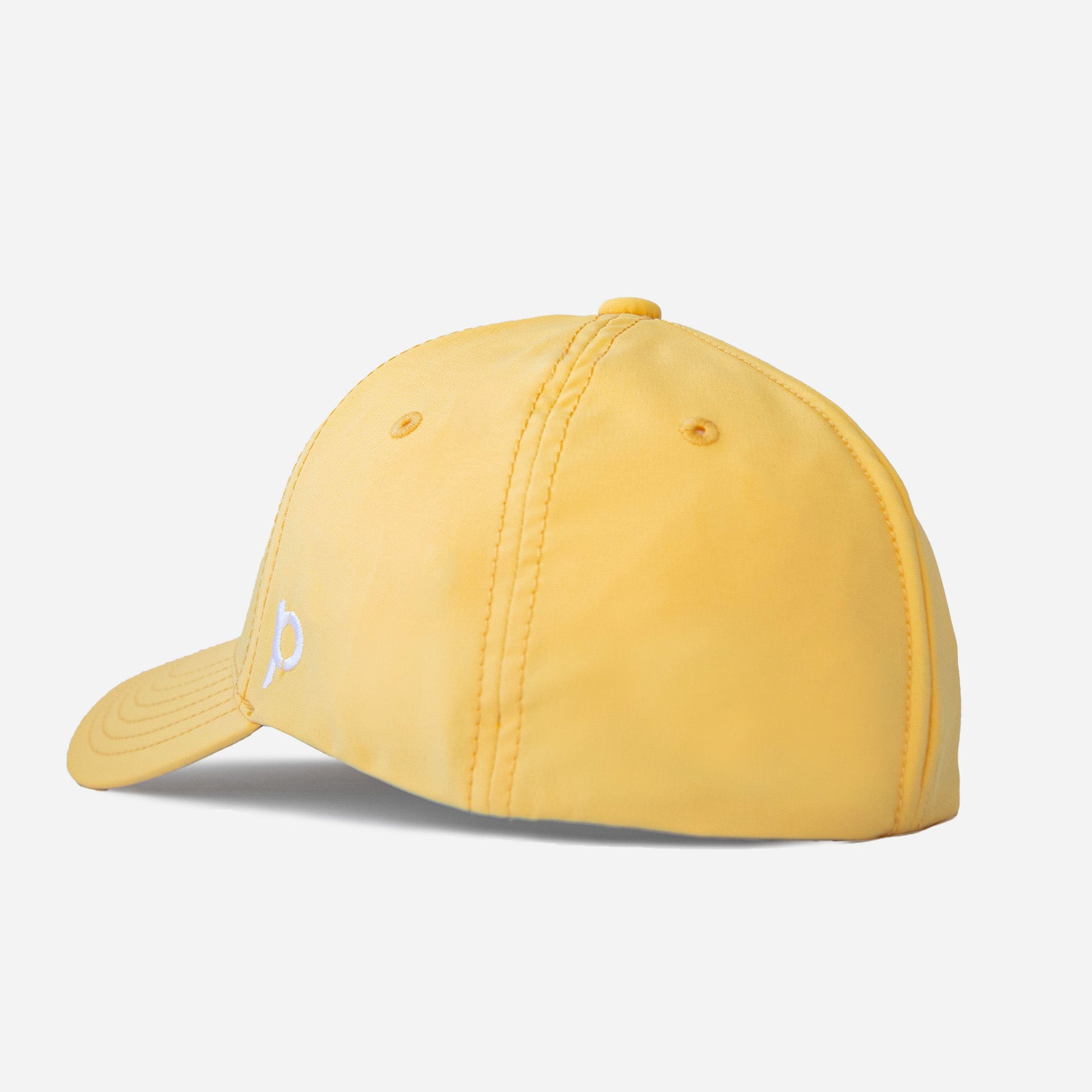 Side profile of a yellow Adventure Fit baseball cap featuring a small white embroidered logo on the brim.