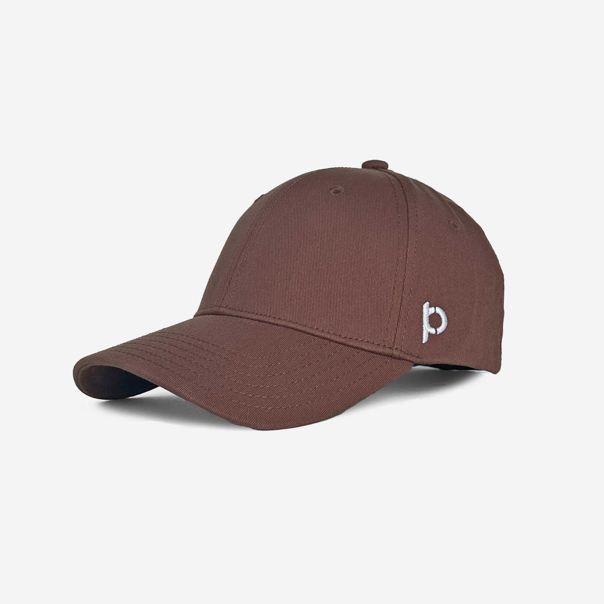 Alt text: "Chocolate brown baseball cap with a curved brim, featuring a small white embroidered logo on the front right side, on a light grey background."